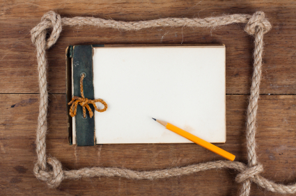 1943 year Antique Old Grunge Notepad in the Rope Frameon wooden background